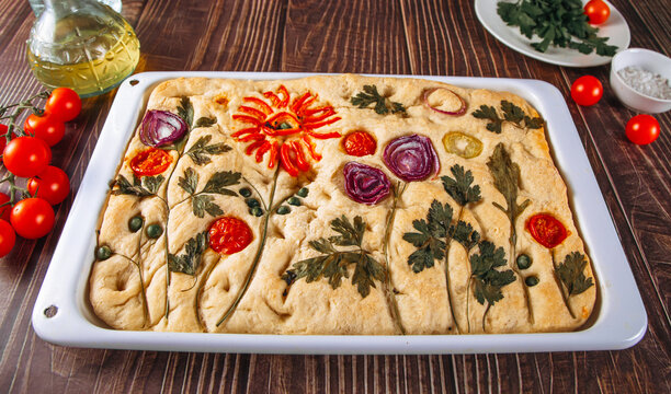 Decorative Italian focaccia bread with floral vegetable art