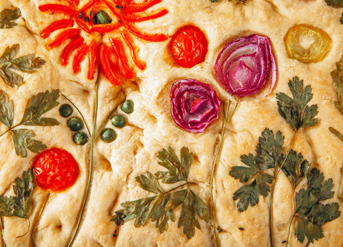 Focaccia bread with edible floral art and vegetables