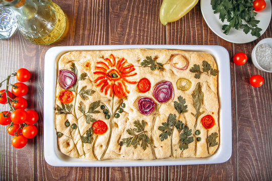 Floral focaccia bread with tomato and herb garden design