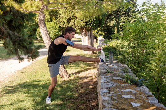 Man stretching in park during yoga warm up outdoors