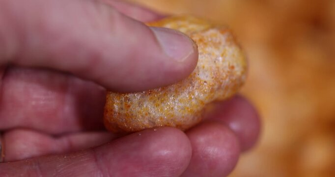 hold crispy mashed potato chips fried in a large amount of sunflower oil, sprinkled with red hot pepper spices, crispy delicious high-calorie chips with spices are scattered on the table