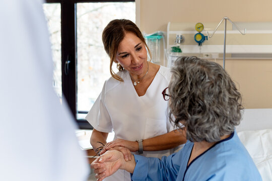 Doctor comforting patient in hospital room interaction