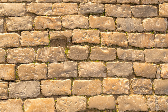 Weathered cobblestone path in Faro under sunlight