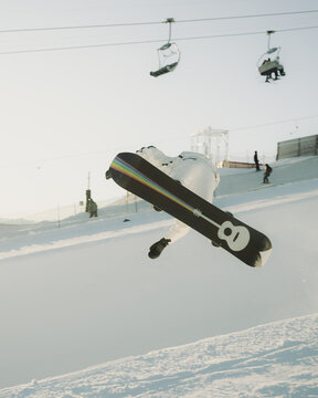 snowboarder in mini halfpipe at the Flims Laax ski resort at sunset