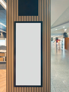 Blank vertical poster in modern shopping mall setting
