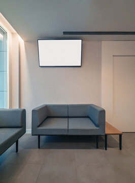 Modern minimalist waiting area with blank screen