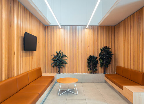 Modern lounge interior with wooden paneling and seating
