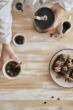 Overhead breakfast coffee setup with grinder and walnut brownie