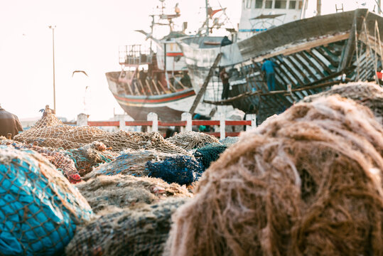 Anchored fishing boat with piled net at Marrakech dock