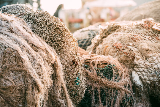 Fishing net pile in harbor with textured rope and mesh