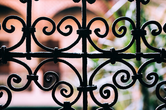 Vintage window with decorative steel security bars closeup