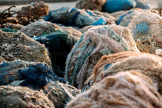 Fishnet pile in harbor with weathered fishing gear