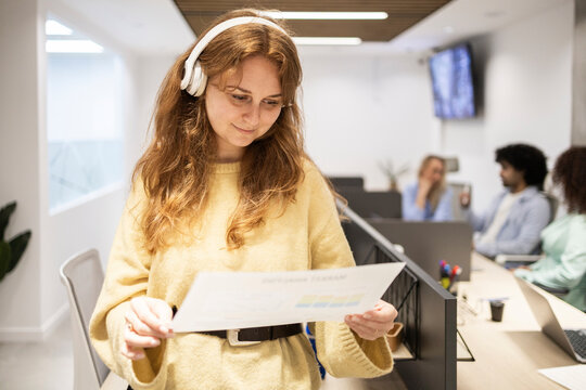 Coworking office team with woman reviewing document