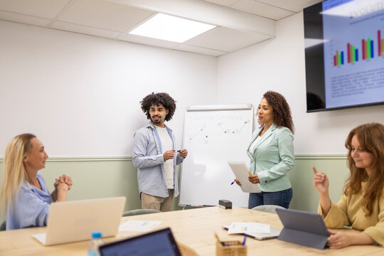 Diverse coworking team meeting and presenting office report