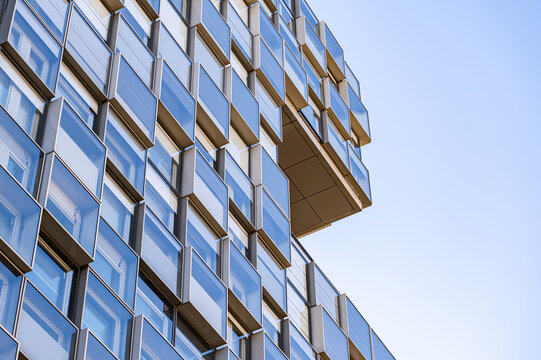 Modern glass building facade detail with geometric panels