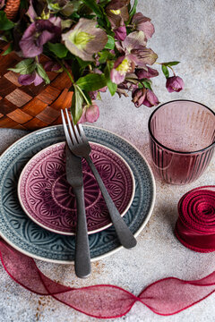 Spring table setting with hellebore and purple glassware