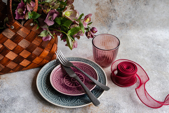 Spring table setting with hellebore bouquet and ribbon