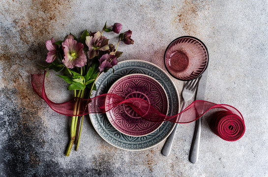 Spring table setting with hellebore bouquet and ribbon