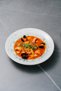 Traditional bouillabaisse seafood soup in saffron tomato broth
