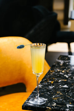 Mimosa cocktail with sparkling wine, orange juice and flower