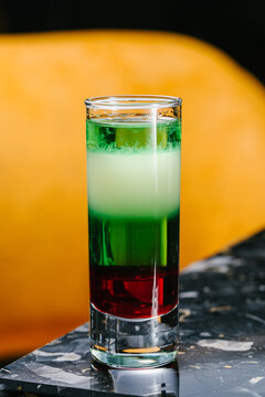 Colorful layered shot cocktail with absinthe and liqueurs