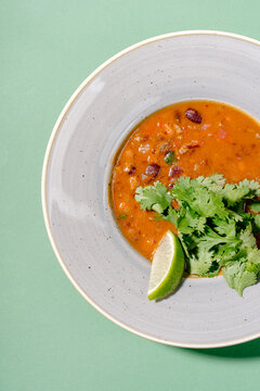 Mexican tomato soup with bean and chorizo in bowl