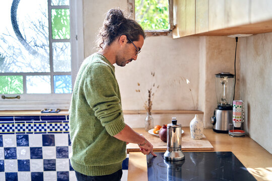 Preparing the first cup of coffee in the morning
