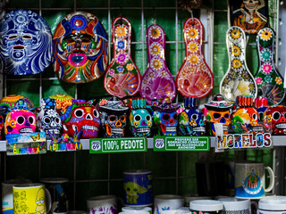 Fototapeta premium Vivid Traditional Mexican Art Display Featuring Sugar Skulls and Decorative Masks