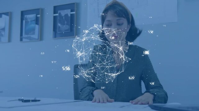 Business office worker reviewing papers, data overlay covering face then fading while using mouse