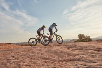 Fototapeta premium People, training and cycling in nature with mountain bike, adventure or workout together for fitness. Space, friends and countryside journey with bicycle, rock terrain or cardio exercise for wellness