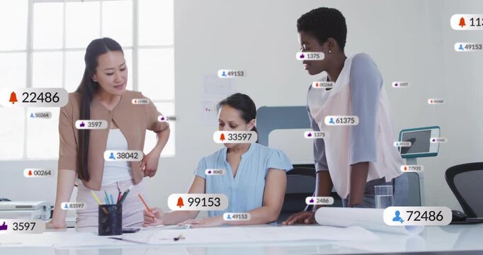 Right woman pointing, team annotating plans and finalizing designs while badges floating over plans