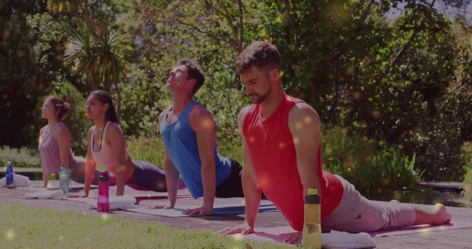 Rightmost man in red top pushing palms on mats, lifting chest on instructor cue, showing alignment