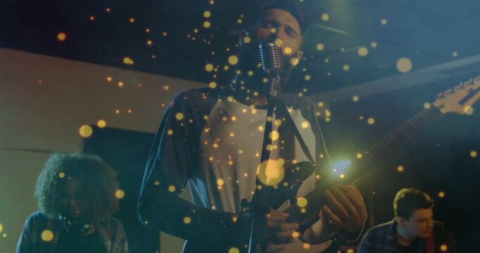 Vertical video: Camera moving forward showing singer playing guitar and singing for band practice
