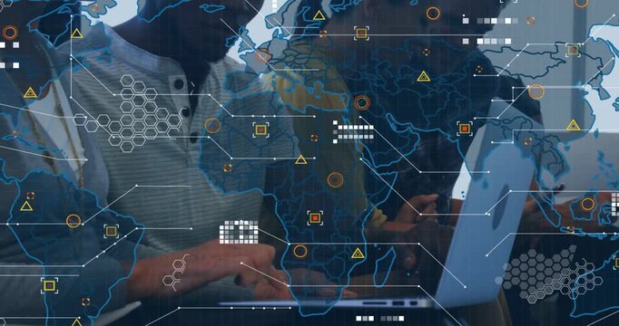 Four colleagues tapping shared laptop and consulting phones, generating tech HUD world map overlay