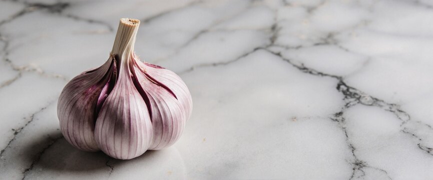 Closeup shot of garlic bulb on marble surface