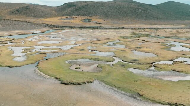 Aerial Top View of Meandering River Flowing Through Vast Wetland