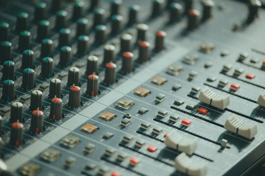 Mixing console. Audio mixer. Green tint of light