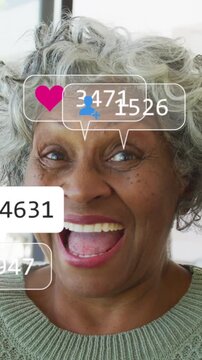 Vertical video: Woman smiling at cam, sparking social icons over face, likes rising, showing reach