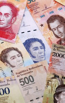 Venezuelan bolivar money bills pile on table. Venezuela banknotes of VES currency close up.