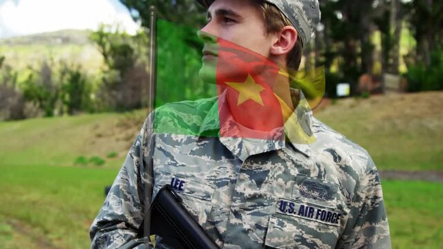 Animation of flag of cameroon over caucasian male soldier with weapon