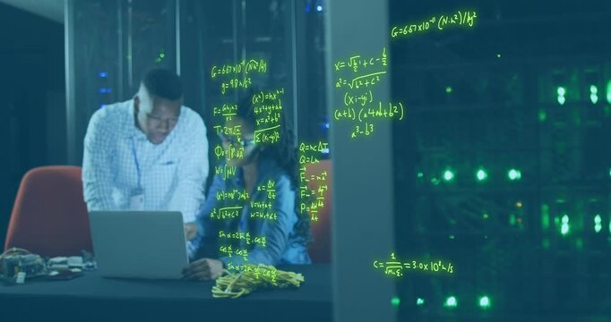 African american computer technicians are working in a business server room, using laptop computers