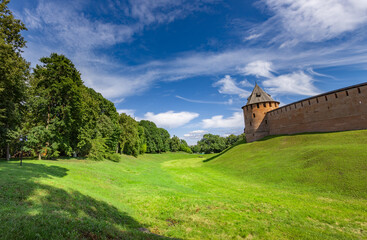 Fototapeta premium Ancient tower stands tall on green hillside
