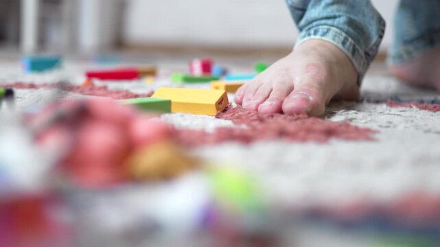 Barefoot Man Stepping on Toy Block on Hardwood Floor - 4K.