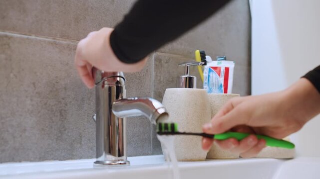 Setting up dental supplies before morning hygiene. Arranging toothbrushes and cleaning tools in front of mirror. Organizing personal dental care items for effective morning oral hygiene routine