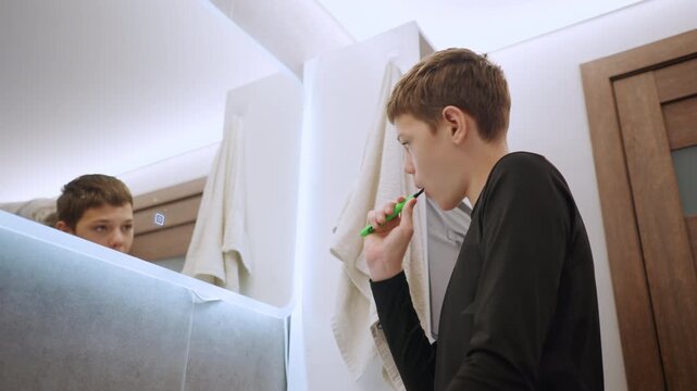 Grandson and grandma bonding. Family members share tender routine of oral care and connection. An affectionate family scene with generations bonding during bedtime teeth cleaning in cozy bathroom