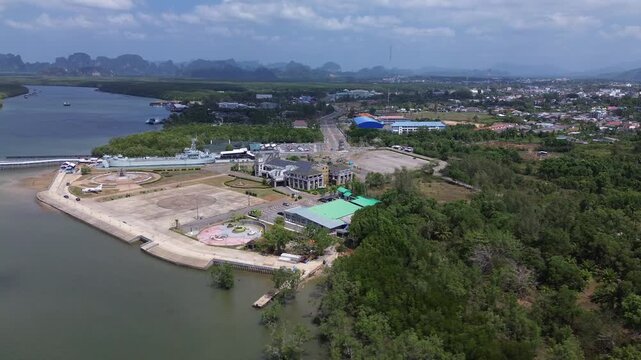 Aerial view of the HTMS Lanta warship museum featuring a decommissioned naval ship and aircraft display near Klong Jilad Ferry Pier in Krabi Thailand coastal area.
Surrounded by stunning nature.