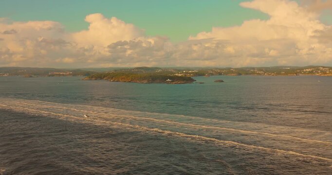 Wide coastal Kristiansand landscape with calm north Skagerrak Sea view on a tourist ship, Agder, Norway