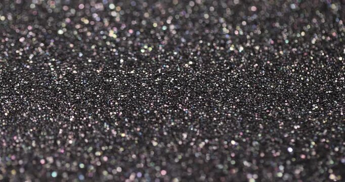 Foam absorbs sound, dark acoustic foam with porous structure and sparkling particles under soft light with sharp details and authentic look of the material in close up.