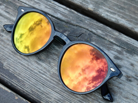 Reflection of the sky at sunset in the lenses of sunglasses, background