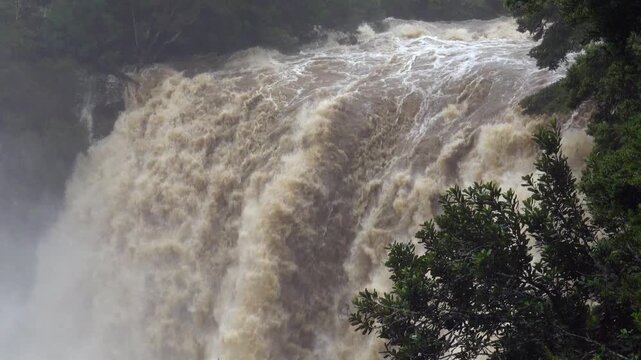 Rainbow Falls in flood after heavy rain powerful waterfall New Zealand